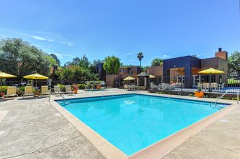 Pool with Yellow Umbrellas and Lounge Chairs at Fountains of Fair Oaks, Fair Oaks, CA